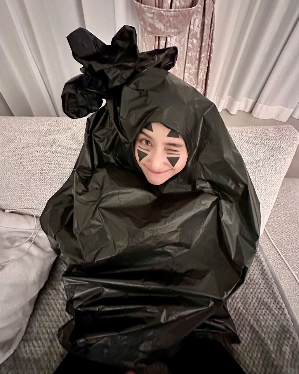 何超蓮笠上黑色垃圾膠袋,全身上下只露出面部,面上更化上宮崎駿動畫《千與千尋》中「無臉男」的妝容,與友人齊齊做「垃圾」,相當盞鬼。 何超蓮笠上黑色垃圾膠袋,全身上下只露出面部,面上更化上宮崎駿動畫《千與千尋》中「無臉男」的妝容,與友人齊齊做「垃圾」,相當盞鬼。