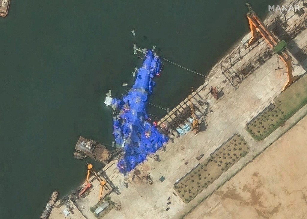 在5月21日下水時發生「嚴重事故」的北韓驅逐艦，現已扶正，並停靠在碼頭。圖為衛星圖片顯示驅逐艦下水後側翻。路透社