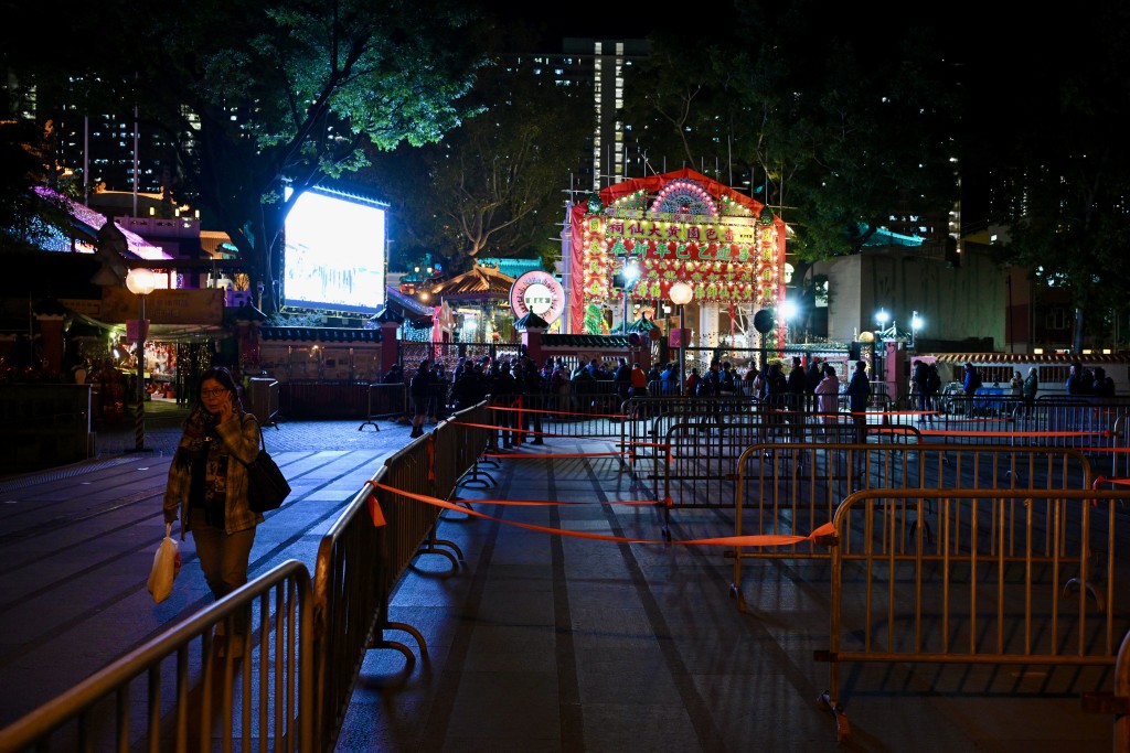 警員在黃大仙祠外廣場架起鐵馬，讓上頭炷香的市民排隊。