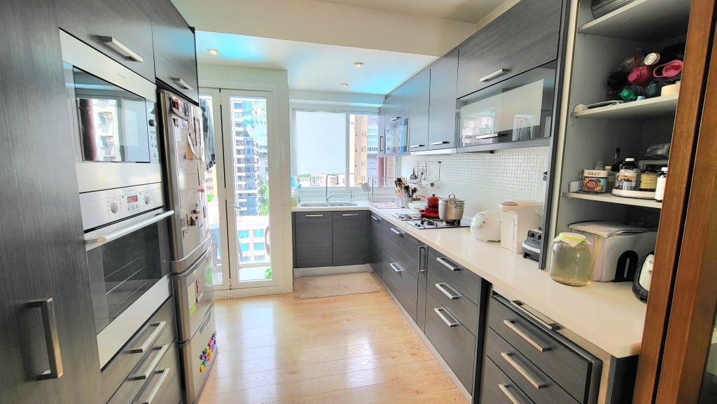 厨房以U形设计，基本家电及厨柜齐全，外连工作平台。