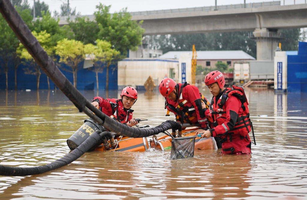 唐山市消防救援支隊隊員8月7日在河北省涿州市市區內進行排澇作業。新華社