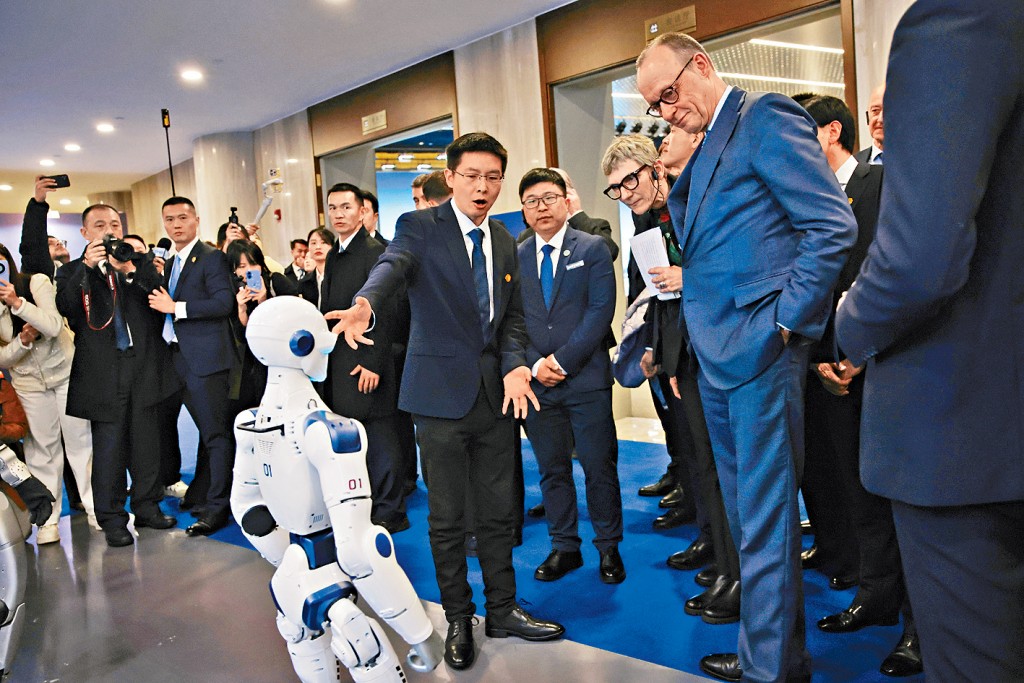 默茨（右）參觀杭州機械人公司宇樹科技，創始人王興興現場講解。