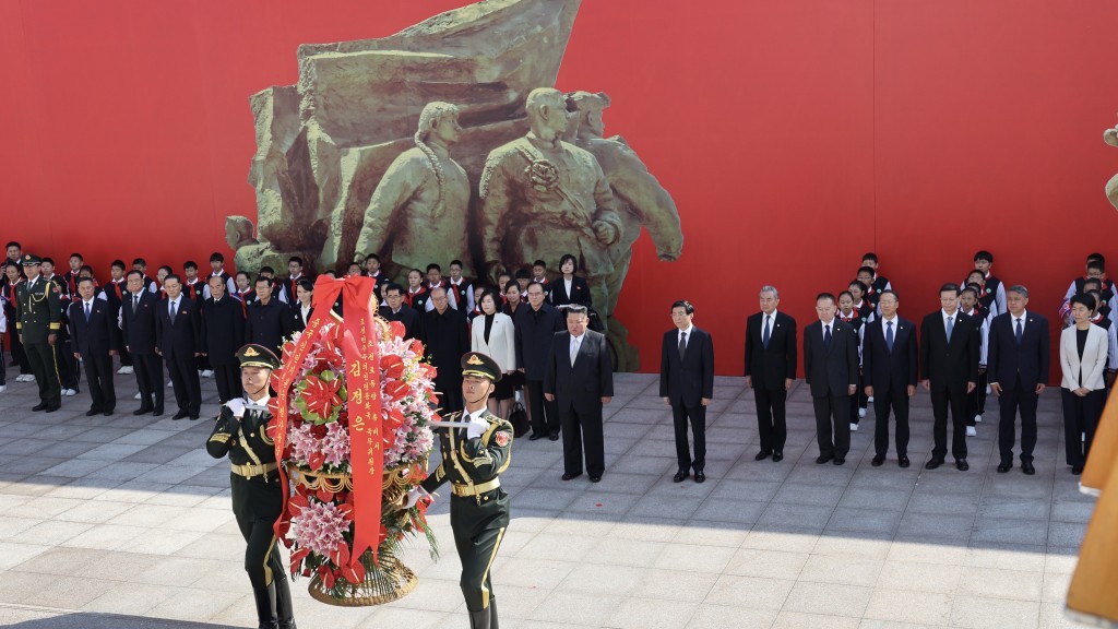 王沪宁陪同金正恩向抗美援朝纪念塔敬献花篮。 新华社