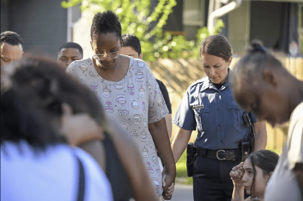 6 月 25 日星期日凌晨，第 57 街和展望大道附近发生枪击事件，导致多人死亡、多人受伤，堪萨斯城警察局长史黛西·格雷夫斯 (Stacey Graves) 与民众手拉著手，聚集在街上祈祷。（美联社）