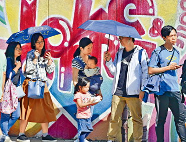 ■元朗區元龍票站外，有不少年輕人及一家大小排隊等候投票。