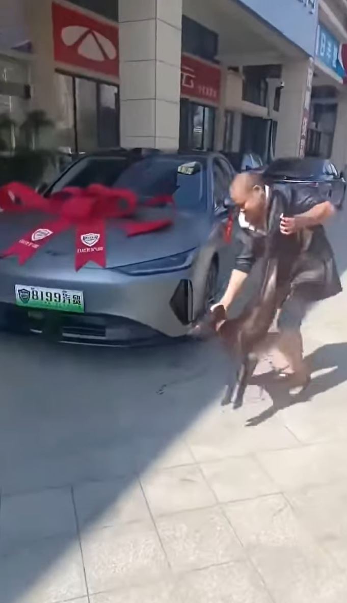 男子繞着新車疑灑上狗血。