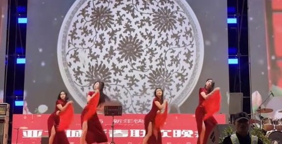 穿上旗袍的女子在台上大跳中国舞。