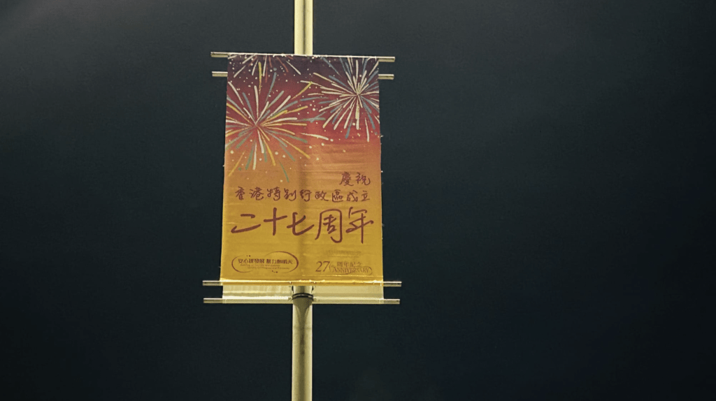 当时工人在为灯柱悬挂庆祝香港特区成立27周年直幡。蔡楚辉摄