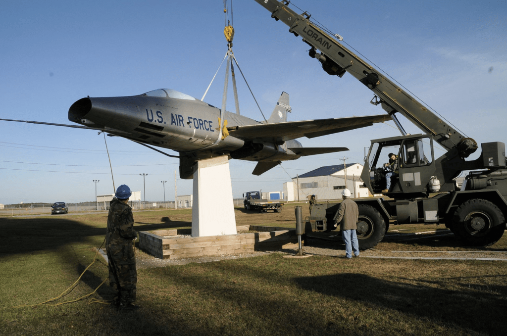 2010 年 11 月 30 日，美國馬薩諸塞州科德角的奧蒂斯空軍國民警衛隊基地，一名飛機修復展覽專家協助土木工程師拆除一架 F-100 靜態飛機。 路透社