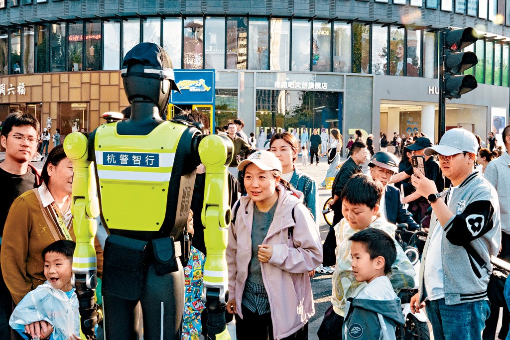 五一期間，路人向機械人交警問路。