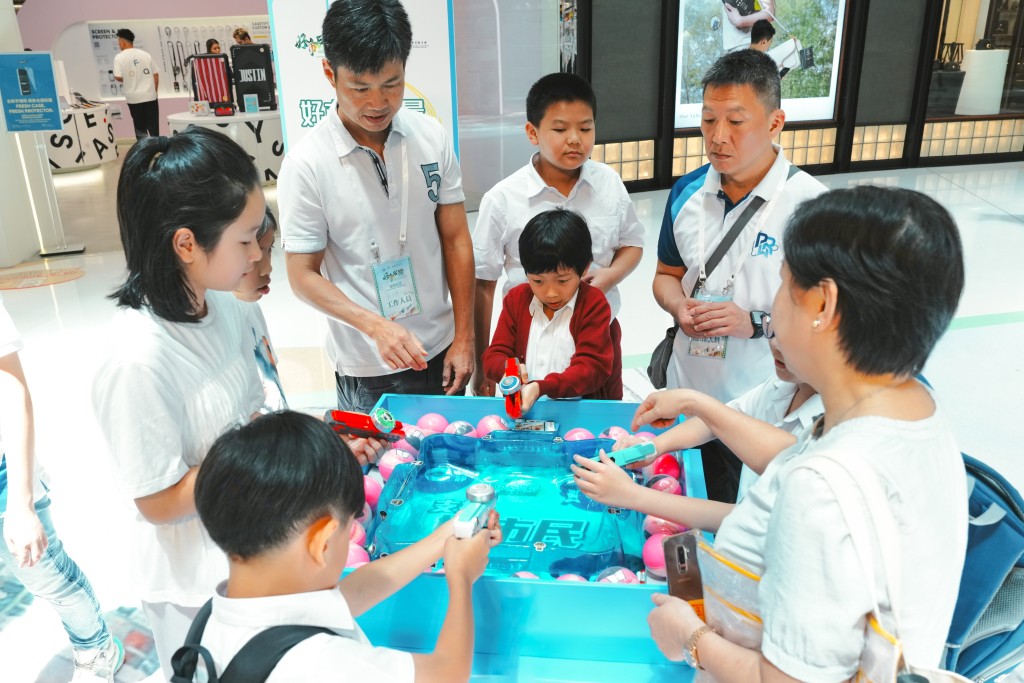 市民於好市民版「陀螺對戰」遊戲攤位中「一決高下」。