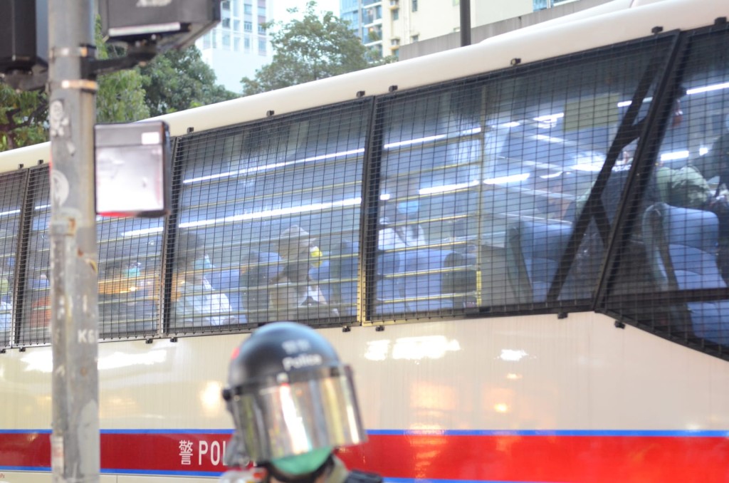 警方將被捕人士帶上警車。