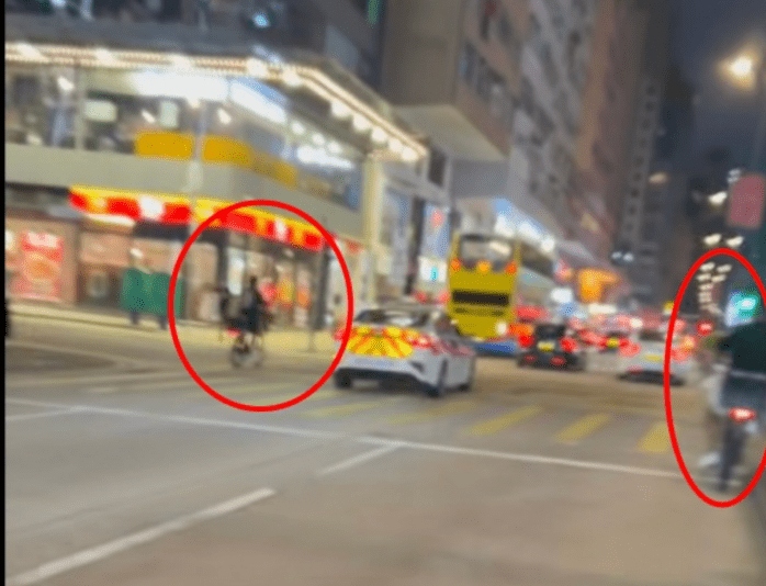 慢線亦有另一名男子駕駛電動單車,兩輛電動單車猶如左右「夾」着警車同行。 慢線亦有另一名男子駕駛電動單車,兩輛電動單車猶如左右「夾」着警車同行。
