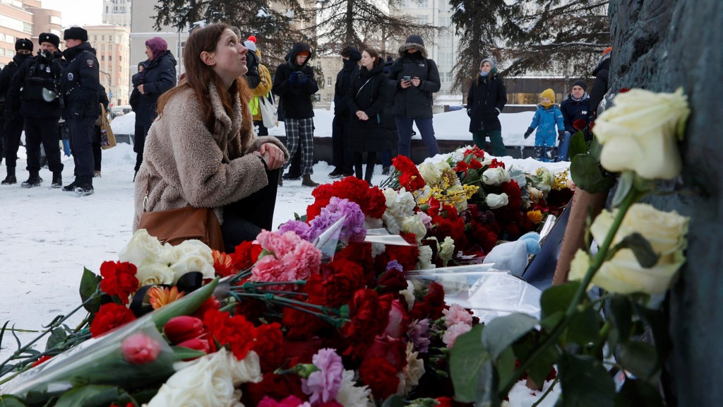一名女子坐在莫斯科悲傷之牆前悼念納瓦爾尼。 路透社