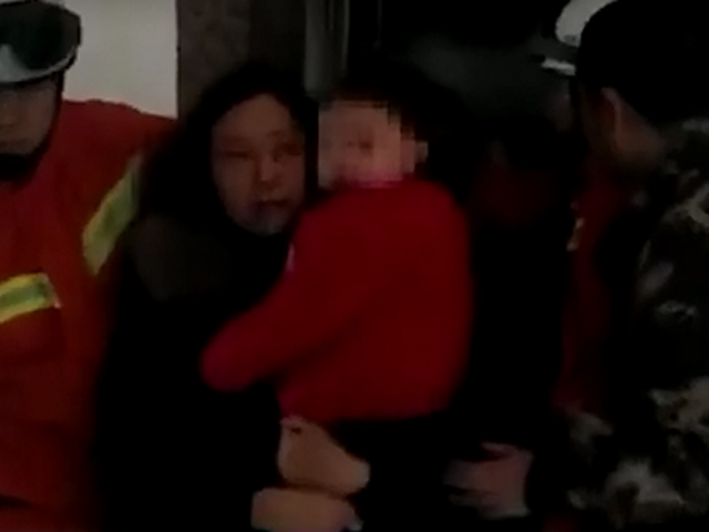 消防員協助救出被困的一對母子。 網上圖片