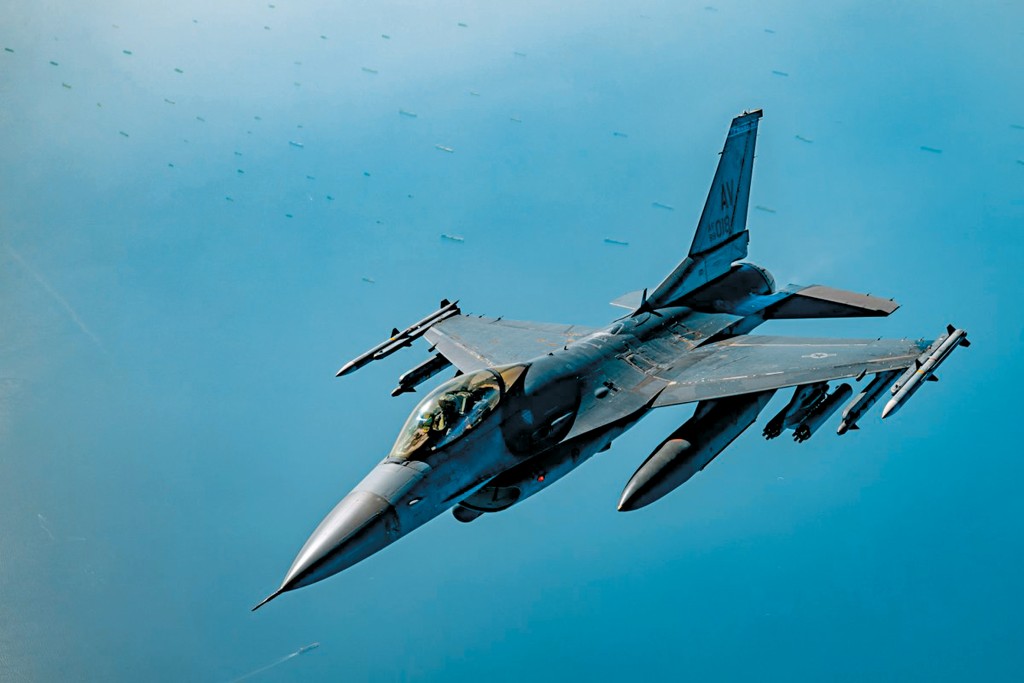 美軍一架F-16戰機在霍爾木茲海峽附近巡邏，下面海域可見大批滯留貨船。