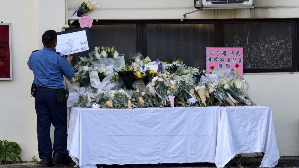 沙田消防局外放置心意桌,有市民到場鞠躬獻花致意,亦有人放下感謝卡。黃文威攝 沙田消防局外放置心意桌,有市民到場鞠躬獻花致意,亦有人放下感謝卡。黃文威攝