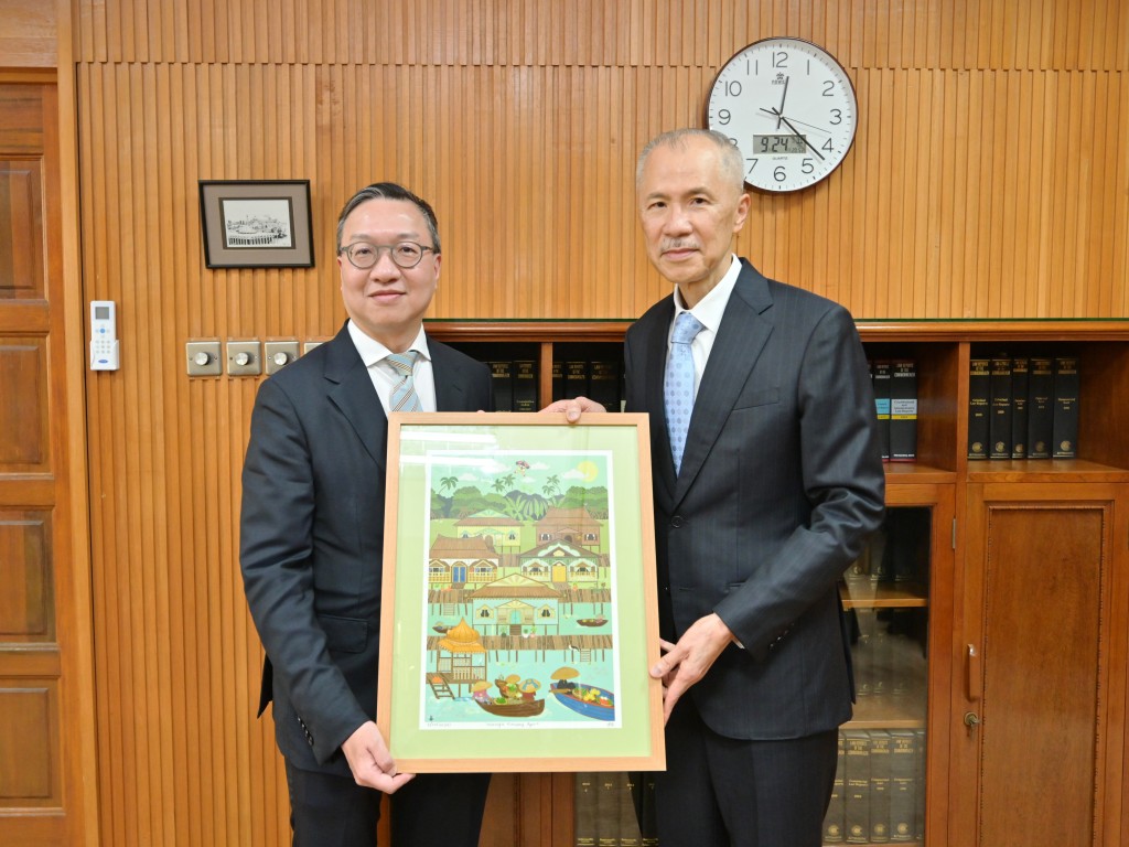 林定国（左）与文莱最高法院首席大法官张惠安（右）会面后交换纪念品。