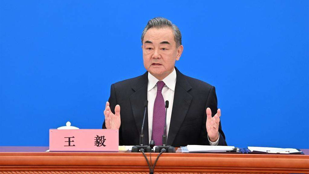 國務委員兼外交部長王毅回答中外記者提問。新華社圖片
