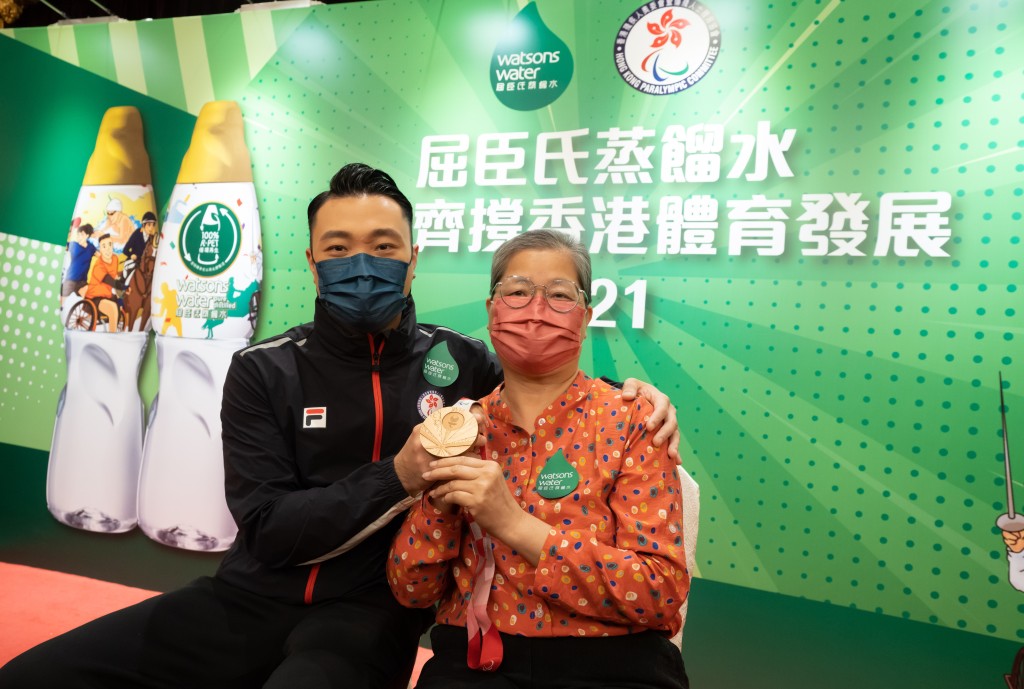 陳浩源的媽媽獲頒發「運動員的最強後盾」獎座。屈臣氏蒸餾水圖片