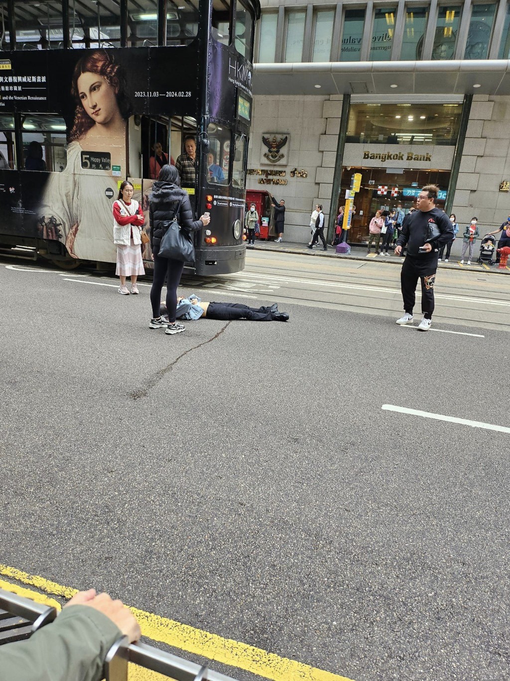多名途人站在女子旁边，避免有驶经的车辆撞倒她。网上图片