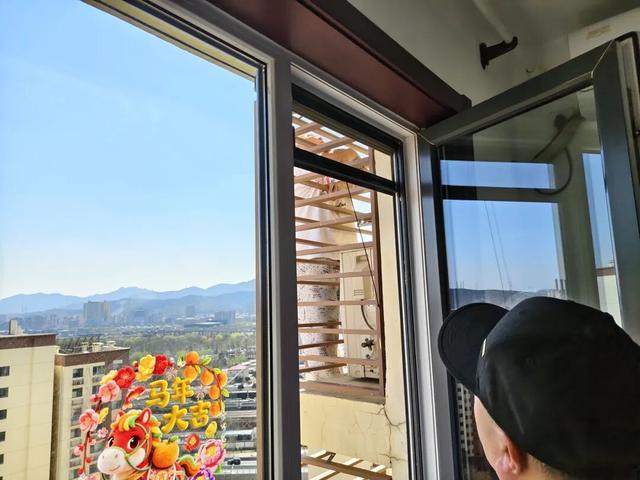 老人挂在冷气外机护栏外，情况危急。