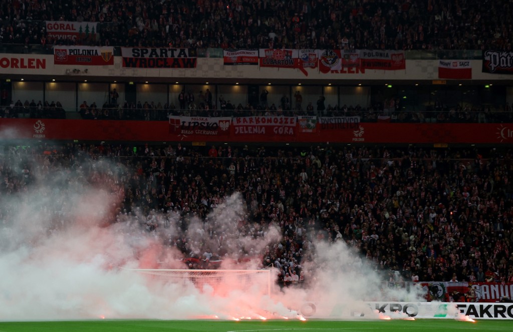 球赛一度因球迷掷烟花入场暂时。路透社