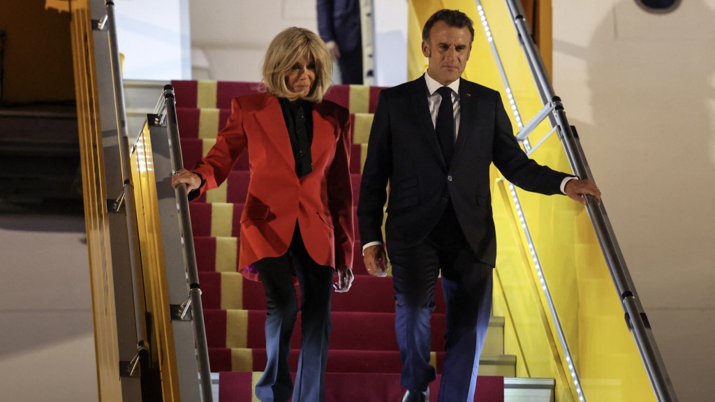 夫人拒絕撓手，兩人各自走完整條梯。法新社