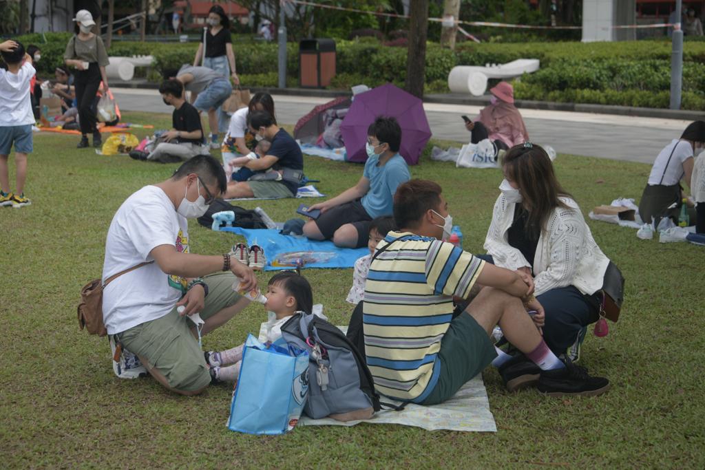 市民在公園草地上野餐紮營。