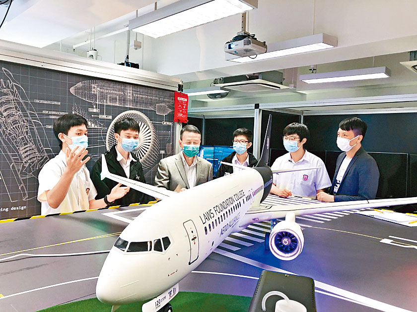 何胤霖（左一）介紹飛機模型如何協助他們學會科學知識。