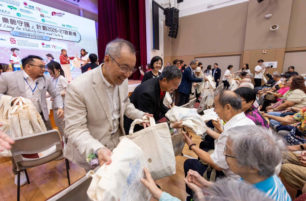 港燈客戶服務總經理梁偉堅向參與啟動禮的長者派發福袋。未來數月，義工會陸續到東區和灣仔區的長者進行家訪，送贈智慧家電和講解用法。 