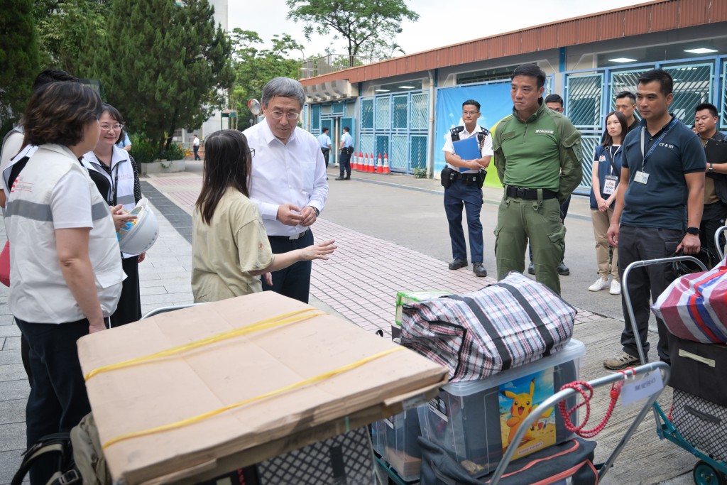 卓永兴在大埔浸信会公立学校，与宏新阁一户完成上楼、正候车离开的住户交谈，她表示很高兴能从单位取回不少物品，工作人员在整个上楼过程中很帮忙。