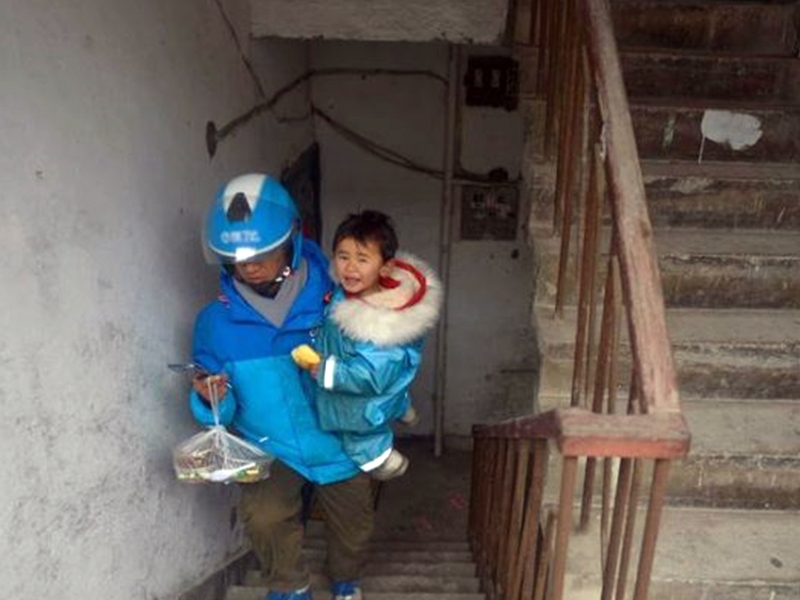 若要送到沒電梯的大樓，李幫勇會一手抱著女兒，一手提著外賣爬樓梯。網圖