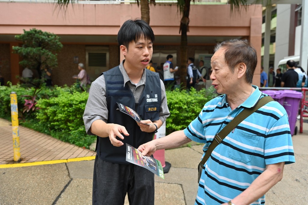海關人員向居民講解反私煙信息。 海關人員向居民講解反私煙信息。