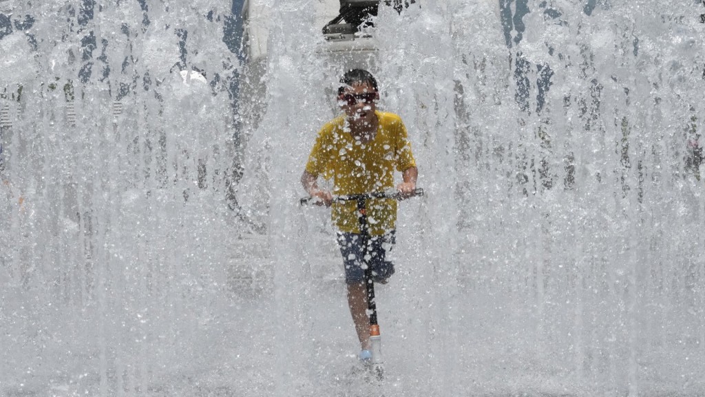 首爾一名男孩在噴泉中玩滑板車。 美聯社