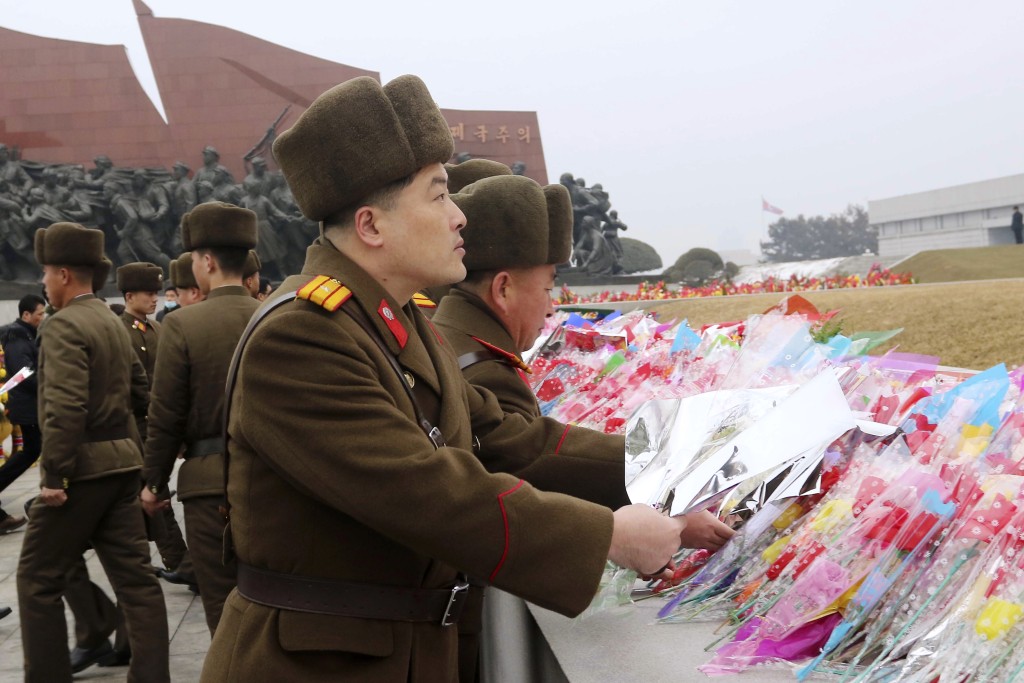 北韓民眾、人民軍官兵、在校學生為萬壽台的金日成和金正日銅像獻花。美聯社