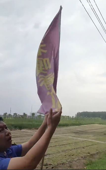 城管人員拆除農民的廣告旗。