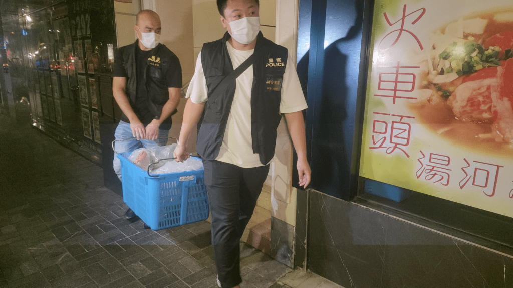 警員從單位內檢走多件證物,該些證物由透明膠袋盛載,疑似是性玩具及潤滑劑。黎志偉攝 警員從單位內檢走多件證物,該些證物由透明膠袋盛載,疑似是性玩具及潤滑劑。黎志偉攝