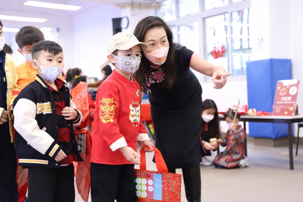 校長與學生參與攤位遊戲，加深學生對中國傳統文化的認識。