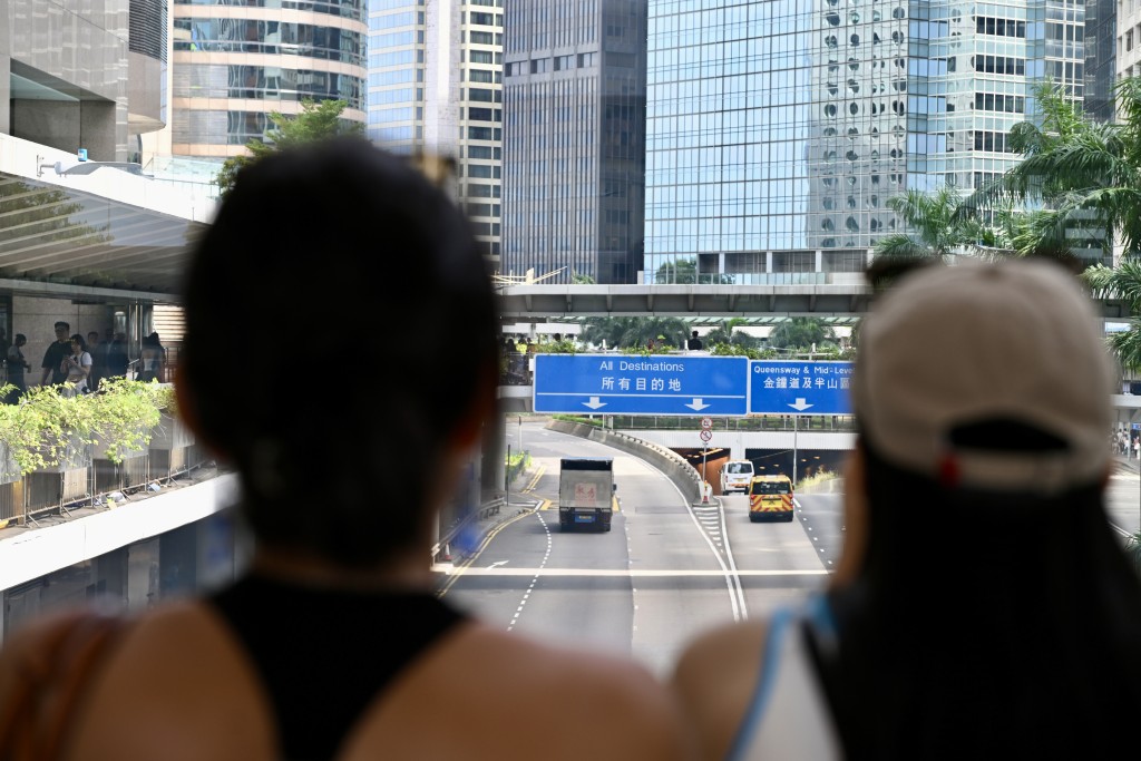 内地游客在中环的“所有目的地”路牌打卡。钟健华摄