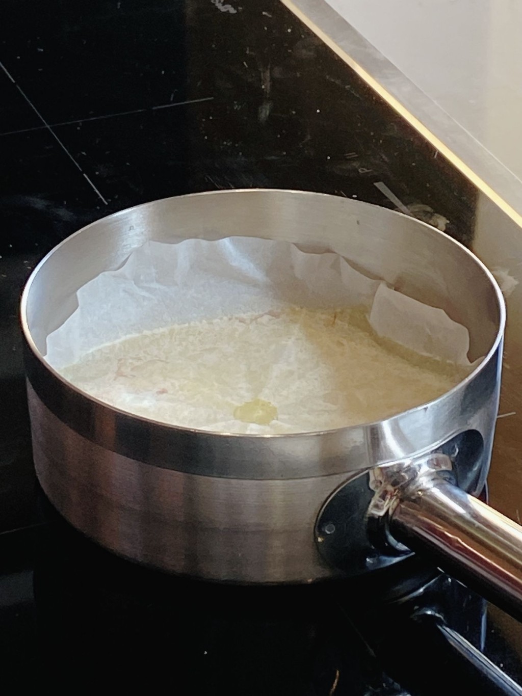 2. 再加入雞高湯，鋪上中間刺穿小洞的焗爐紙，蓋上。放入預熱至攝氏180度焗爐焗18分鐘。