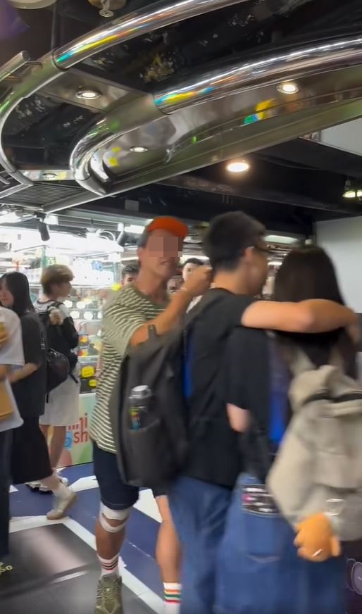 綠帽男情緒激動，逼向黑衫情侶。fb「香港突發事故報料區及討論區」影片截圖