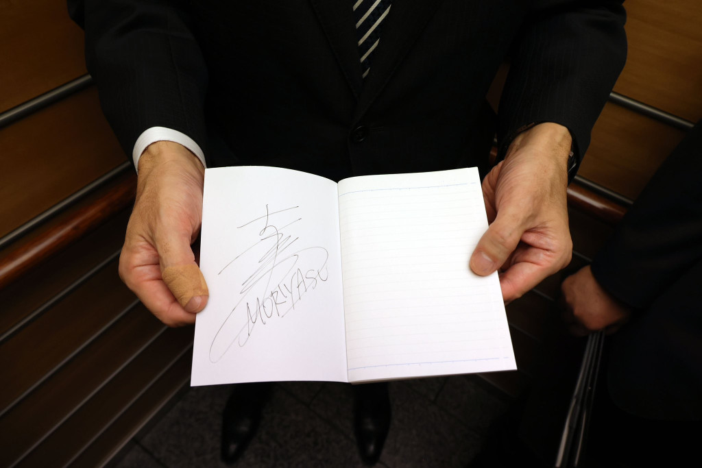 森保一在筆記本簽名贈予首相岸田文雄。網上圖片
