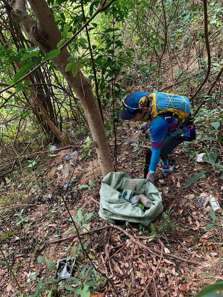 行山愛好者走到山坡撿垃圾。（香港行山遠足之友(吹水山谷）圖片）
