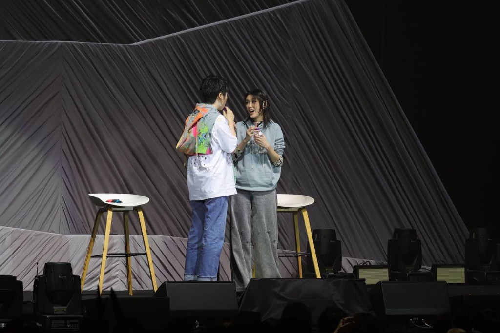 二人在台上答谢对方并来个抱抱。
