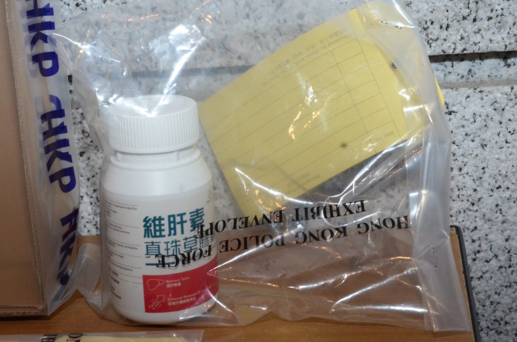 警方在疑犯單位內撿獲一樽護肝素的膠囊。