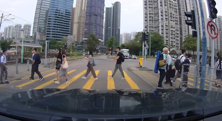 交通燈紅燈，車輛停在燈前，行人熙來攘往過馬路。fb車cam L（香港群組）Simon Yip