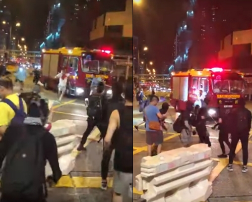 白衣男子在消防車前遇襲。影片截圖