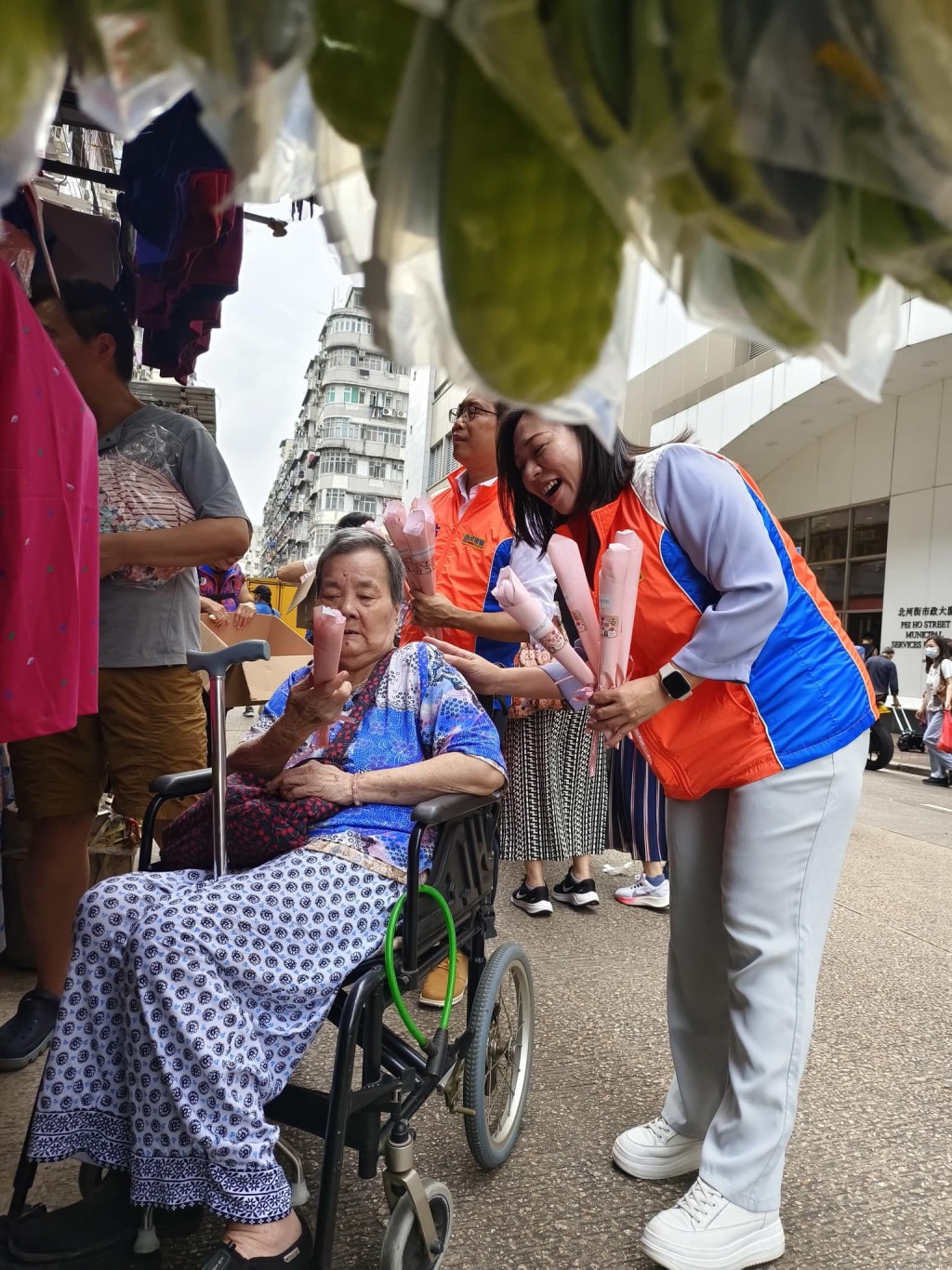 南昌中关爱队队长兼深水埗区议员刘佩玉昨联同义工向街坊送赠香皂花，受惠者包括坐着轮椅的婆婆。（受访者提供）