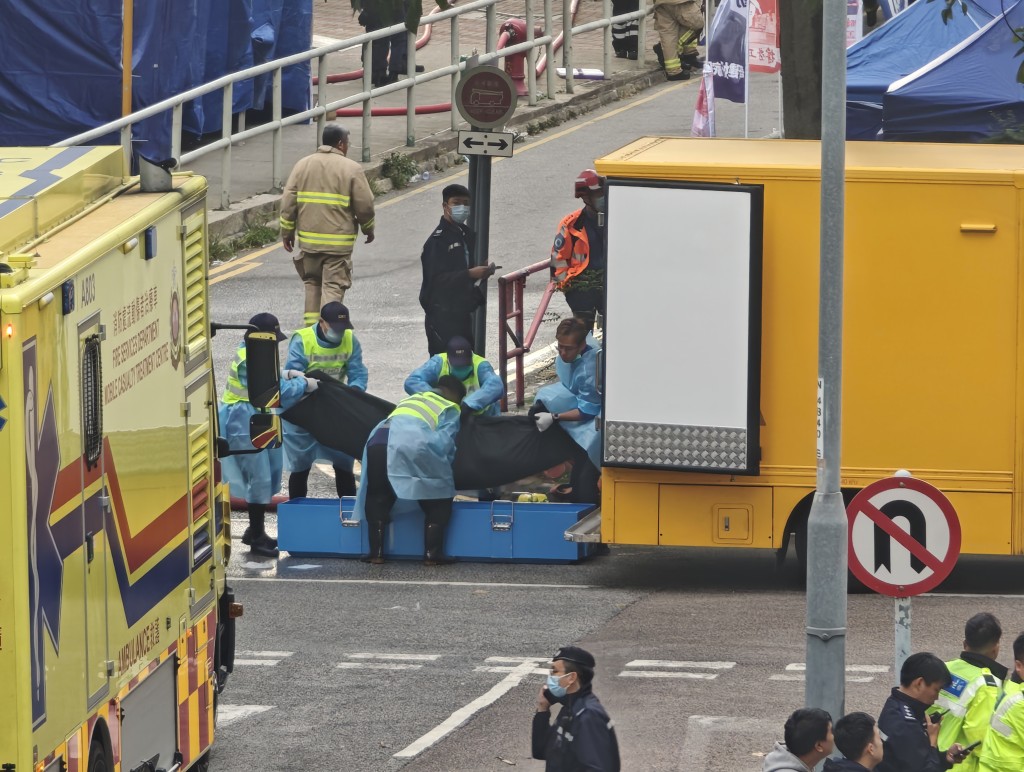 仵工將宏福苑五級大火中的死者遺體，送往殮房。